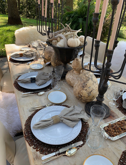 Tall antiqued iron candelabra adding candlelight to an elegant tablescape