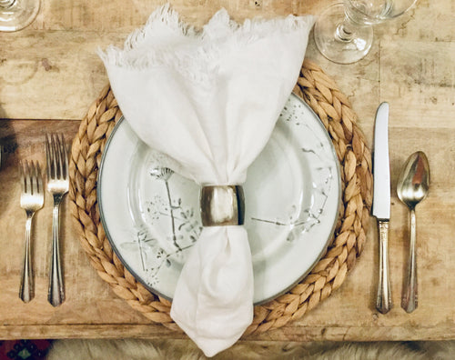 Classic white linen napkins styled with tabletop accents